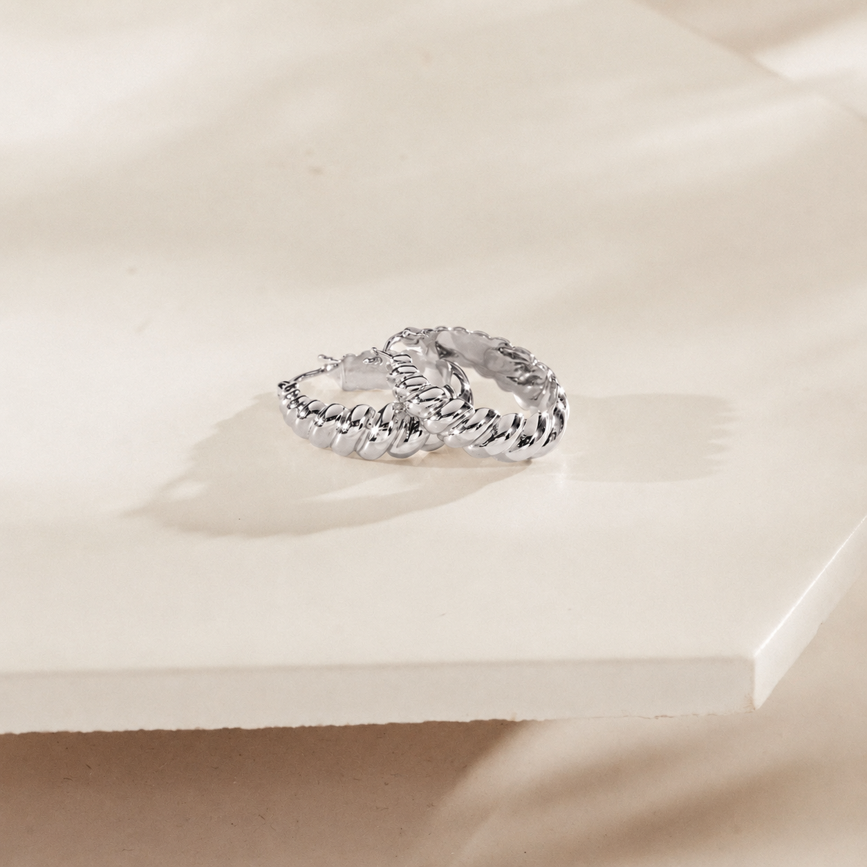Silver ring on a light beige surface